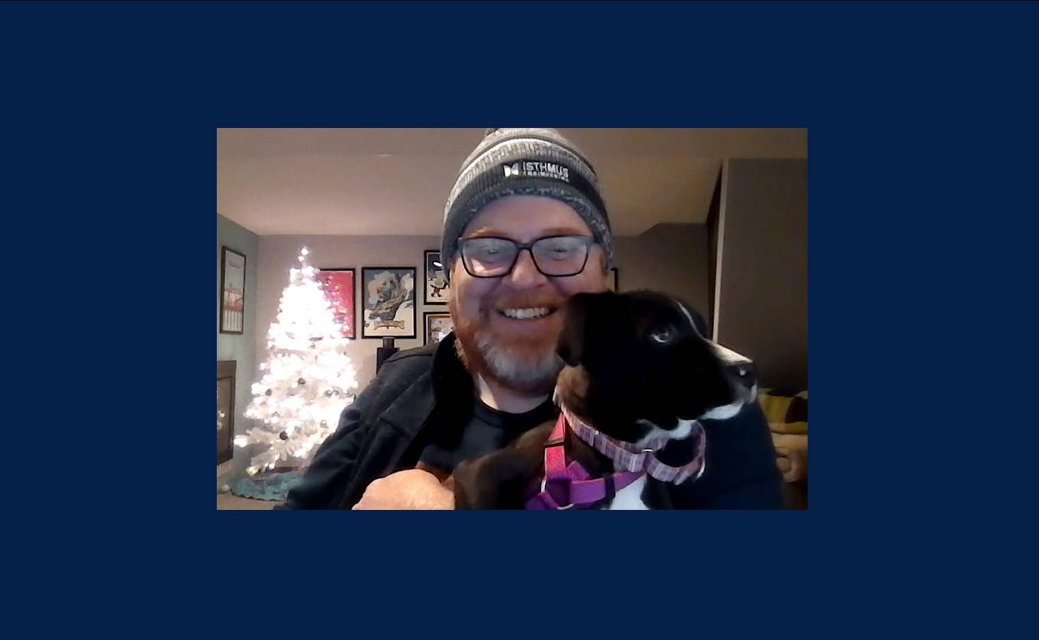 Andrew holding his black and white puppy