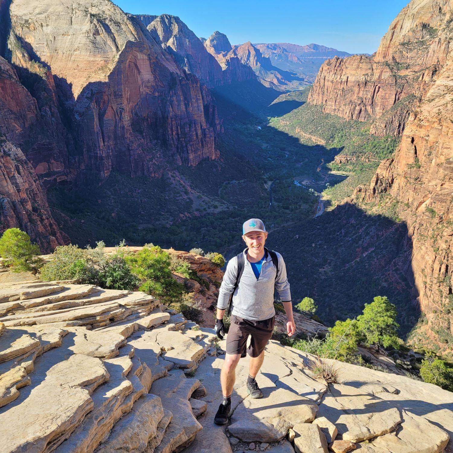 Jason standing in front of a canyon surrounded by mountains