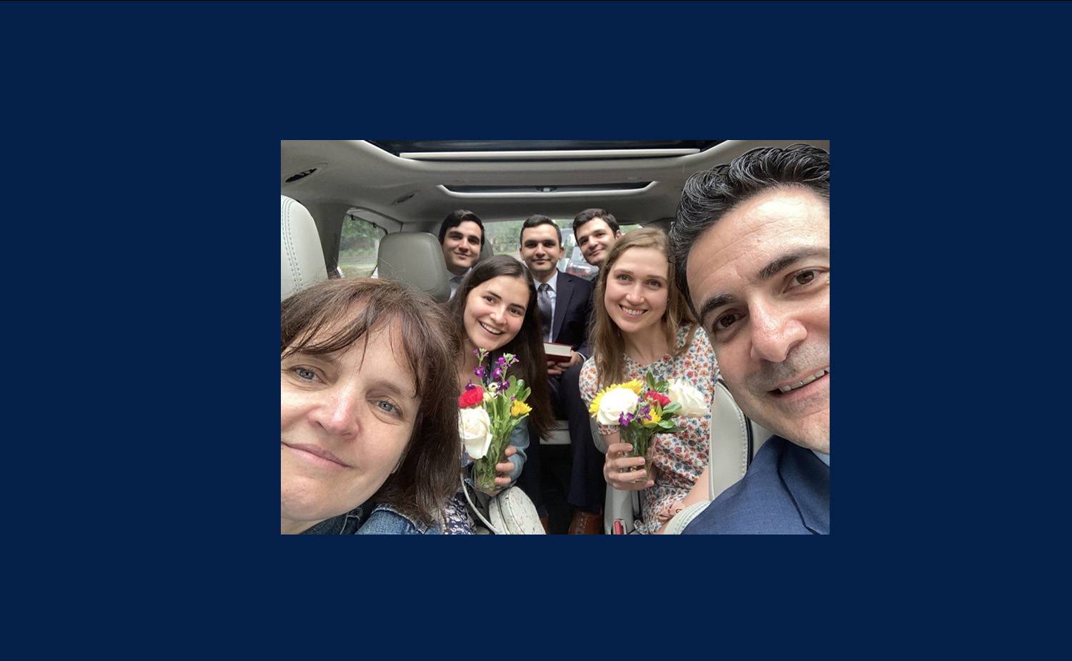 Katie, her husband, and five adult children riding in a van